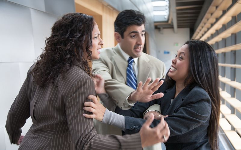 conflict management, man stopping a conflict corporate