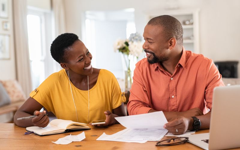 man and woman holding paper, financial planning