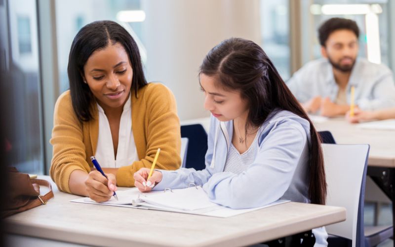 woman tutoring young girl student